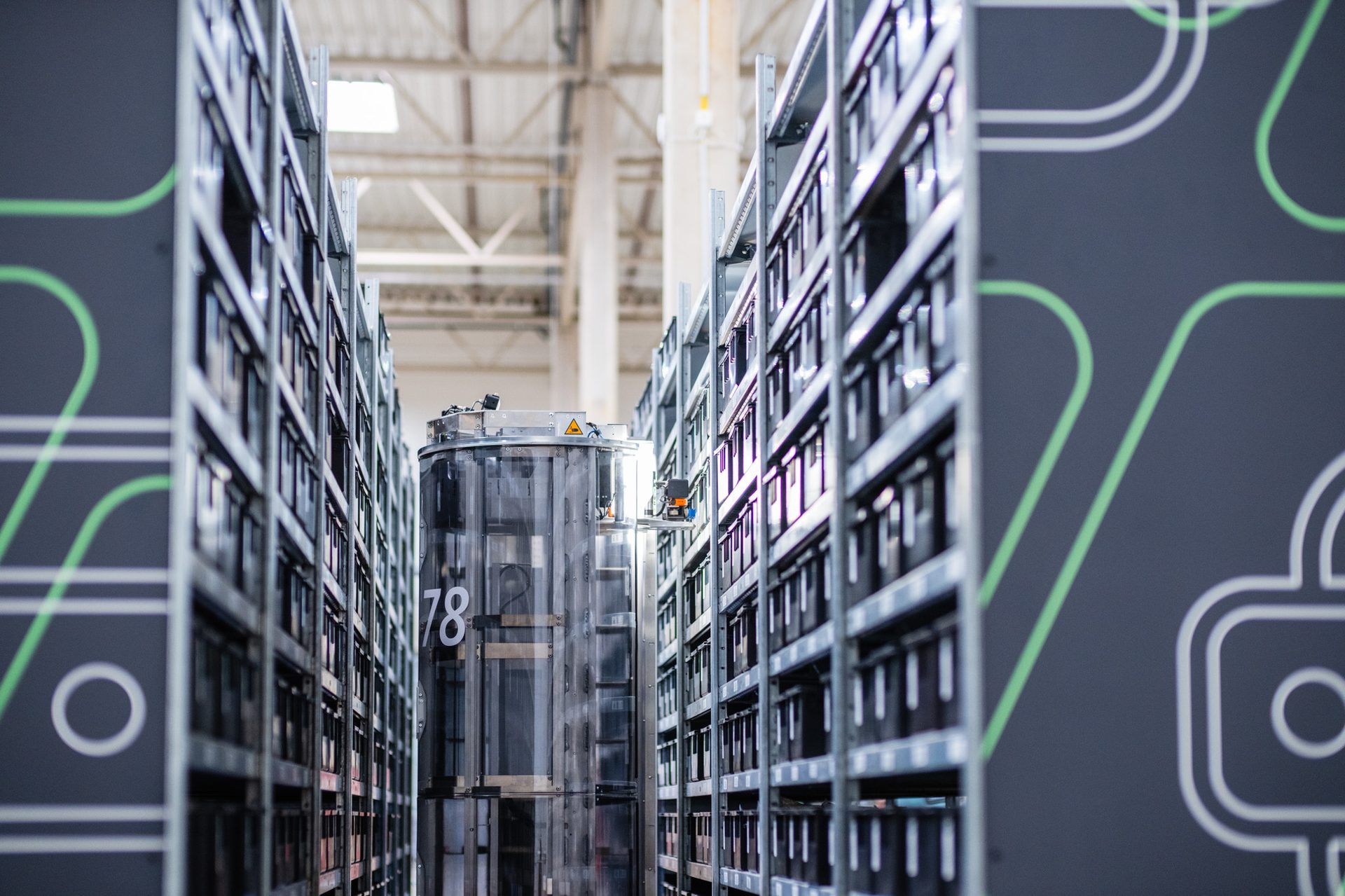 Autonomous mobile robot in a NEO-branded warehouse aisle