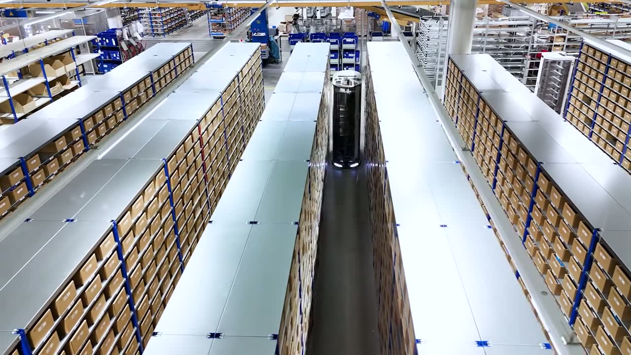 Autonomous mobile robot in the aisle of a shelf-based warehouse, seen from above